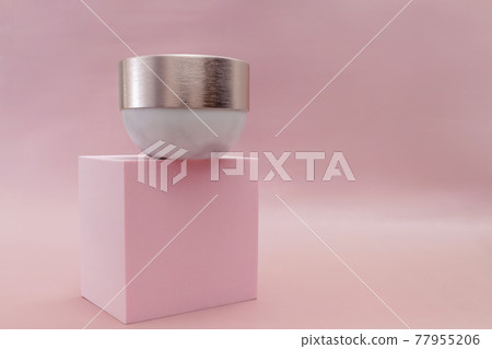 Mockup moisturizer cream in jar standing on pedestal on pastel pink background 77955206