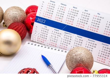 Calendar 2022 and Christmas decorations. Planning for next year. Notebook, New Year's celebration. Calendar 2022 and Christmas decorations. Planning for next year. Notebook, New Year's celebration. 77955314
