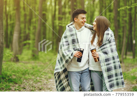 Beautiful couple spend time in a spring forest 77955359