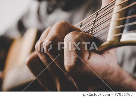 Close up of man hand playing guitar. Close up of man hand playing guitar. 77955703