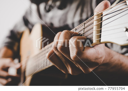 Close up of man hand playing guitar. Close up of man hand playing guitar. 77955704
