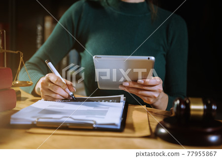 Lawyer working with paperwork on his desk in office workplace for consultant lawyer in office. Lawyer working with paperwork on his desk in office workplace for consultant lawyer in office. 77955867