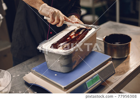 Man making gelato ice cream in professional kitchen Man making gelato ice cream in professional kitchen 77956308