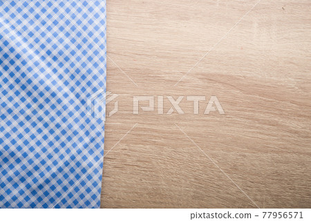 Checkered blue napkin on wooden background. Checkered blue napkin on wooden background. 77956571