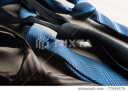 Silk neck ties on wooden background. Silk neck ties on wooden background. 77956579