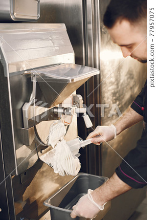 Male confectioner making ice cream at manufacture 77957075