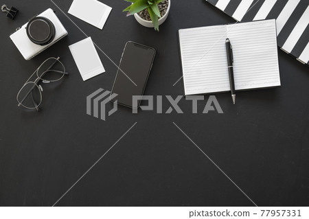 Office black workspace with office supplies and copy space on black background, flat lay Office black workspace with office supplies and copy space on black background, flat lay 77957331
