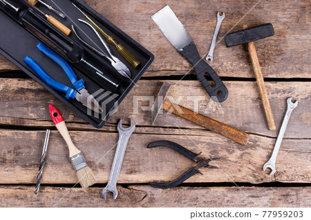Vintage hand tools on rustic background. 77959203