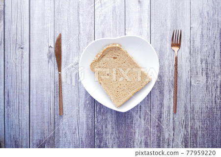 close up of slice of baked bread on plate on table close up of slice of baked bread on plate on table 77959220