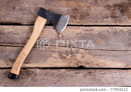 Top view of an axe on rustic wooden boards. Top view of an axe on rustic wooden boards. 77959222