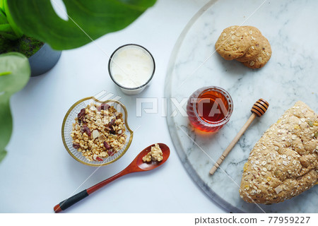 cereal breakfast in bowl ,bread and honey on white background cereal breakfast in bowl ,bread and honey on white background 77959227