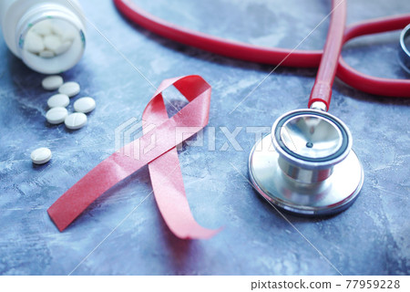 Red ribbon HIV, and stethoscope on black background. Red ribbon HIV, and stethoscope on black background. 77959228