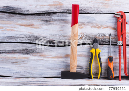 Set of construction tools on wooden background. Set of construction tools on wooden background. 77959231