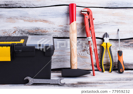 Different repair tools on wooden background. Different repair tools on wooden background. 77959232