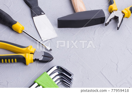 Different construction tools on gray background. 77959418