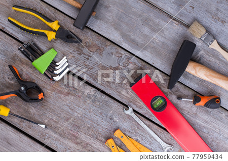 Border frame of construction tools on rustic background. Border frame of construction tools on rustic background. 77959434