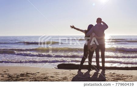 Happy family enjoying sunset in the summer leisure. Concept of friendly family. The couple relax 77960439