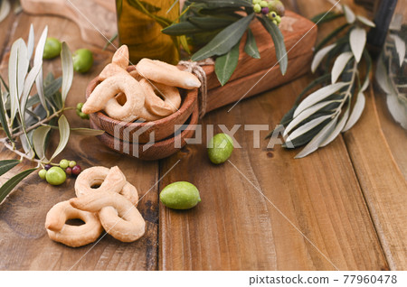 Italian wine appetizer Tarall on a wooden table.i. Traditional salted biscotti south of Italy. Above 77960478