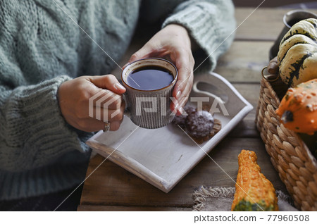 Autumn concept, pumpkins, hot steaming cup of coffee on a wooden table background. Seasonal, morning 77960508