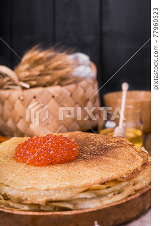 Shrovetide Maslenitsa Week festival meal. Stack of russian pancakes with red caviar. Rustic style Shrovetide Maslenitsa Week festival meal. Stack of russian pancakes with red caviar. Rustic style 77960523
