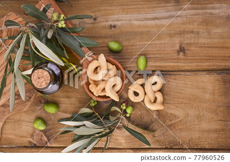 Italian wine appetizer Tarall on a wooden table.i. Traditional salted biscotti south of Italy. Italian wine appetizer Tarall on a wooden table.i. Traditional salted biscotti south of Italy. 77960526