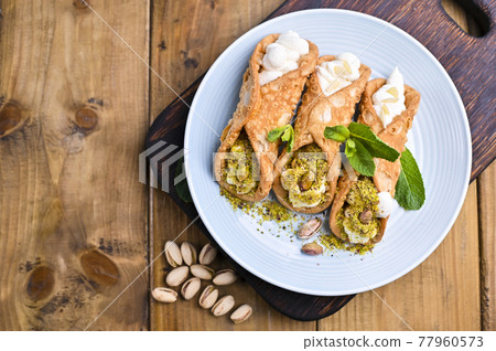 Cannoli Sicily. Traditional Italian sweet with ricotta and various fillings. Food on a wooden 77960573