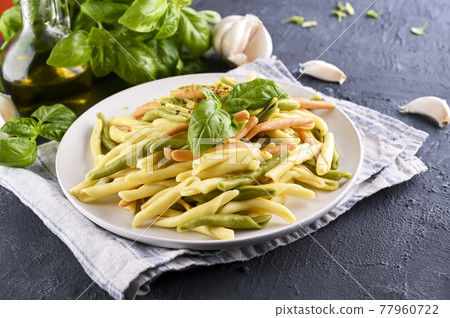 Traditional pasta trofie south of Italy with pesto and basil. Homemade meal for lunch. Healthy Traditional pasta trofie south of Italy with pesto and basil. Homemade meal for lunch. Healthy 77960722