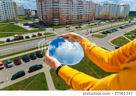 An oval mirror with a reflection of the blue sky An oval mirror with a reflection of the blue sky 77961347
