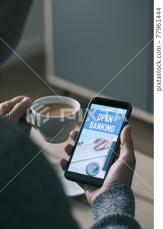 text open banking in the smartphone of a young man text open banking in the smartphone of a young man 77961444