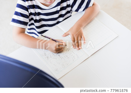 Elementary school boy practicing hiragana at home 77961876