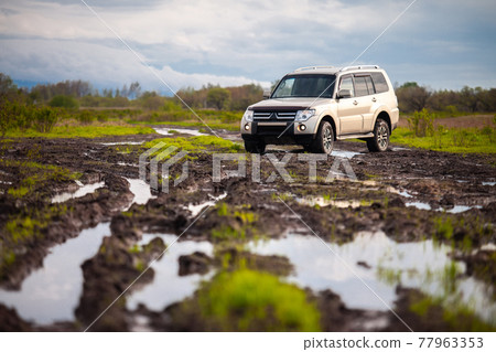 Mitsubishi Pajero/Montero at dirt road after rain 77963353