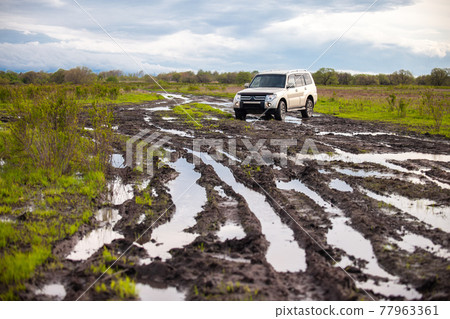 Mitsubishi Pajero/Montero at dirt road after rain 77963361