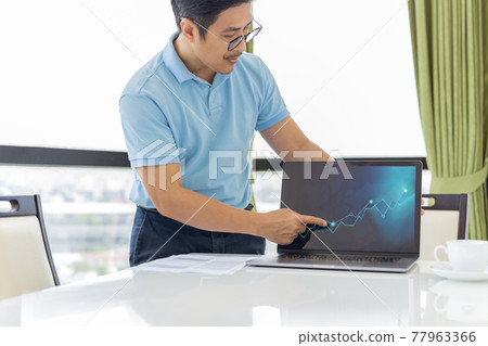 Businessman pointing strategy graph chart on laptop in the office. 77963366