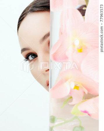 Beautiful young Woman and Flowers in the Bottle Beautiful young Woman and Flowers in the Bottle 77963573
