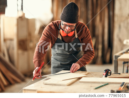Joiner making marks on wooden detail 77965015