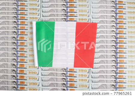 Italy flag on a background from dollar banknotes. Concept of the relationship of the italian money in relation to the dollar, the country's economy, financial 77965261