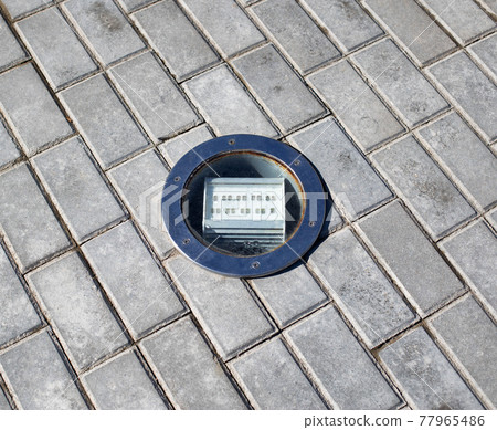 outdoor diode floodlight built into the tile, close-up. Illumination outdoor diode floodlight built into the tile, close-up. Illumination 77965486