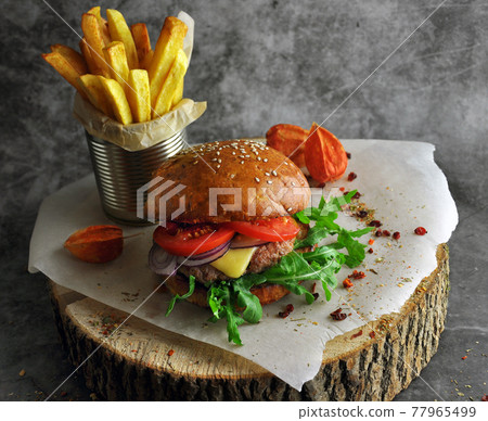 Burger on a wooden board. Burger on a wooden board. 77965499