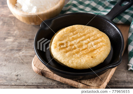 Arepas on wooden table Arepas on wooden table 77965655