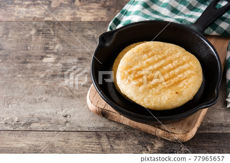 Arepas on wooden table 77965657