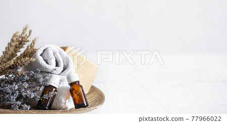 Spa composition with natural aromatic oil and lavender sprigs copy space. Spa composition with natural aromatic oil and lavender sprigs copy space. 77966022