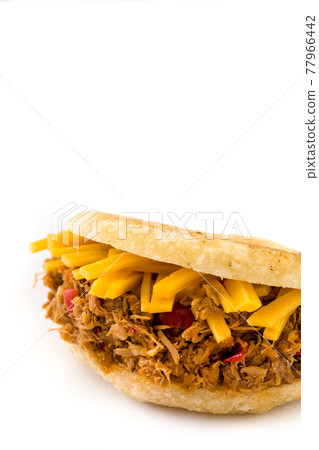 Arepa with shredded beef and cheese isolated on white background. Arepa with shredded beef and cheese isolated on white background. 77966442