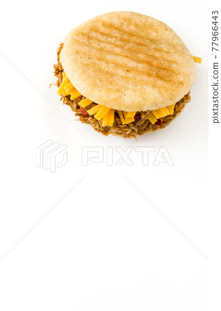 Arepa with shredded beef and cheese isolated on white background. Arepa with shredded beef and cheese isolated on white background. 77966443