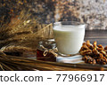 Honey, milk, nuts on table. 77966917