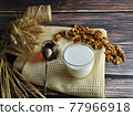 Honey, nuts and milk on a dishcloth. 77966918