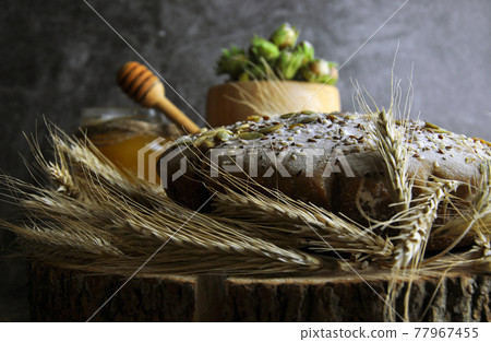 Bread with seeds, side view. Bread with seeds, side view. 77967455