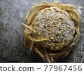 Round bread with seeds. Top View 77967456