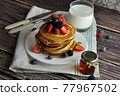 Pancakes with berries close-up. 77967502