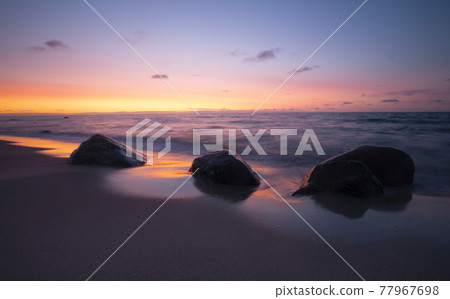 Beautiful sunset at the beach of a national park in sweden after a summers day Beautiful sunset at the beach of a national park in sweden after a summers day 77967698