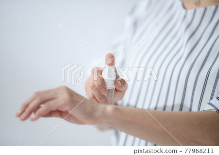 Senior woman sunscreen insect repellent at hand 77968211